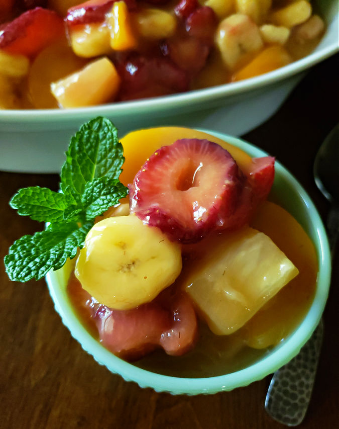 easy fruit salad with fresh fruit and canned fruit in a vanilla pudding glaze