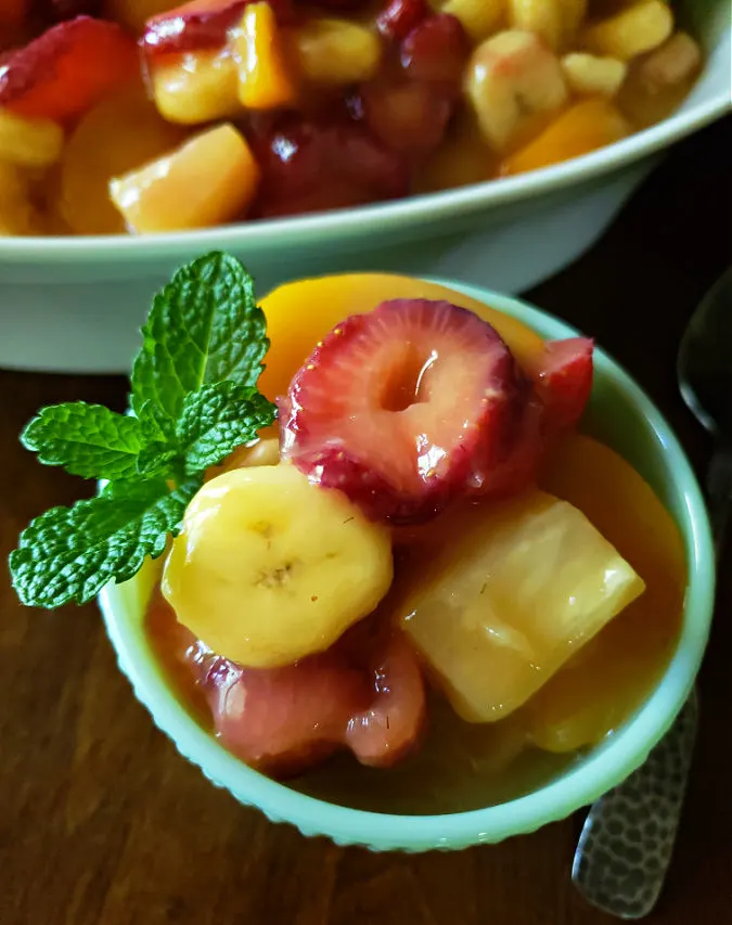 easy fruit salad with fresh fruit and canned fruit in a vanilla pudding glaze
