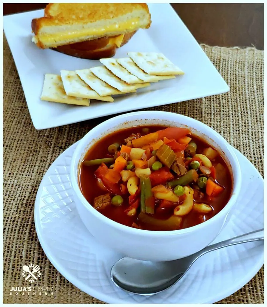 Bowl of homemade V8 Vegetable Soup with crackers and a grilled cheese