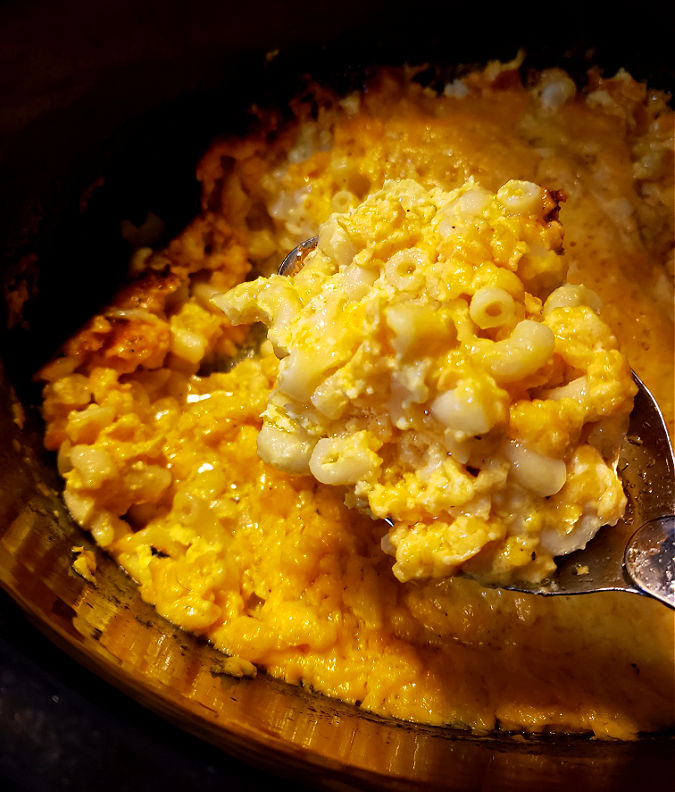 Using a serving spoon to serve slow cooker macaroni