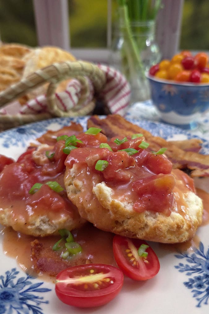 Fresh homemade buttermilk biscuits covered with old fashioned tomato gravy