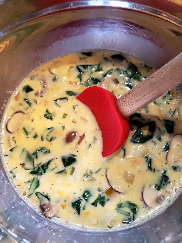 Custard mixture with vegetables for quiche in a mixing bowl