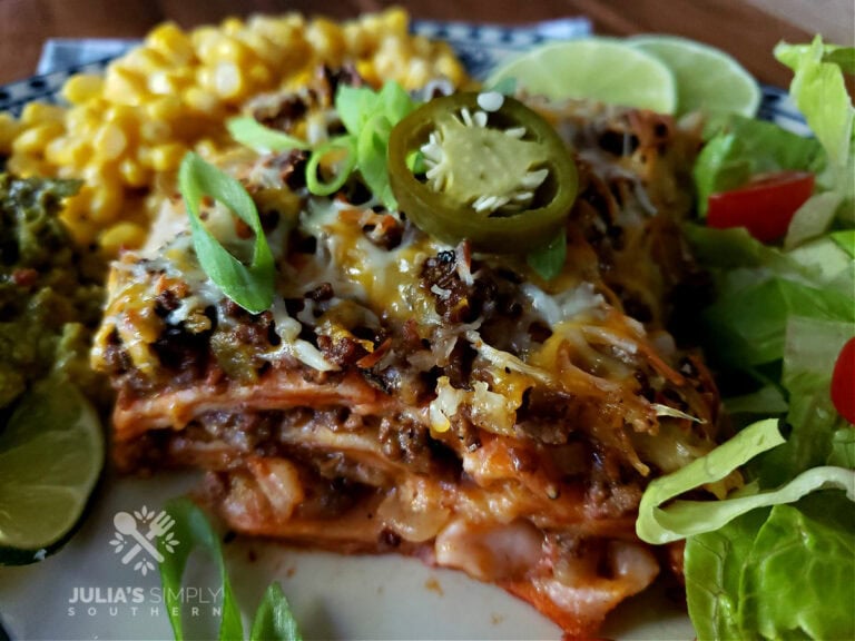 Enchilada Casserole served with a salad, guacamole, sour cream and corn