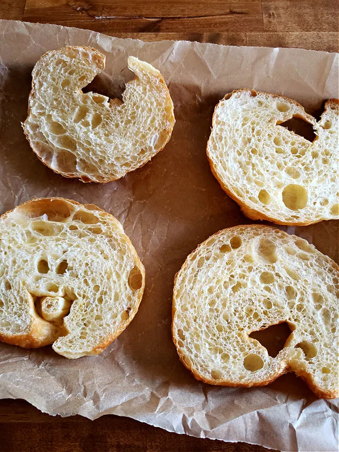 flaky buttery croissants cut in half on a sheet pan