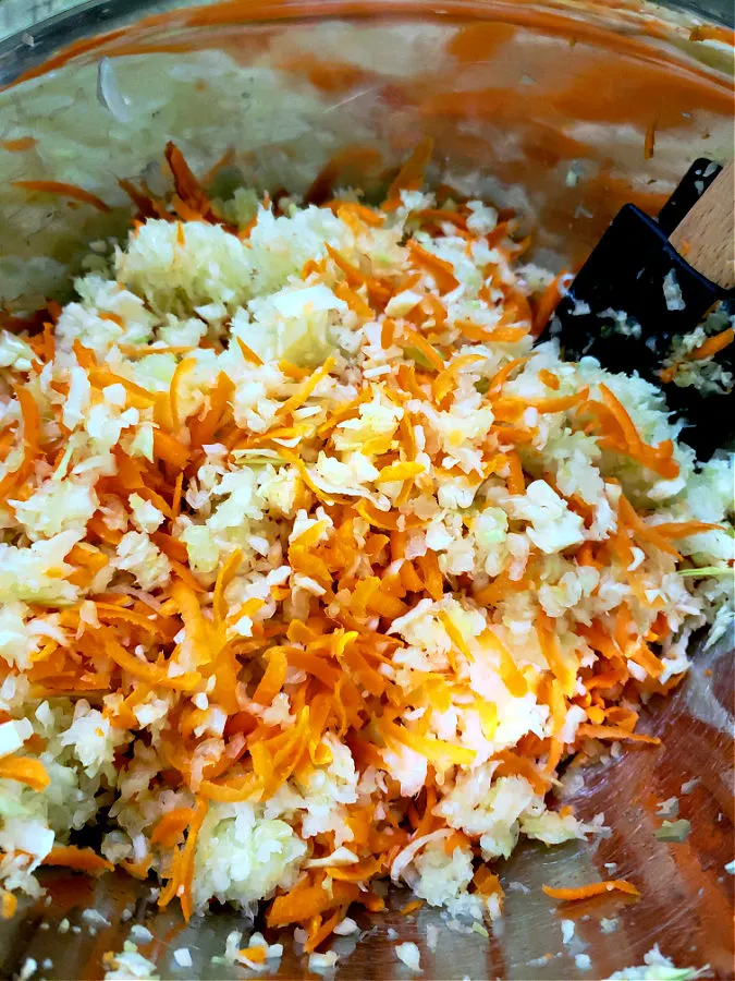 cabbage and carrots coleslaw mixture in a mixing bowl