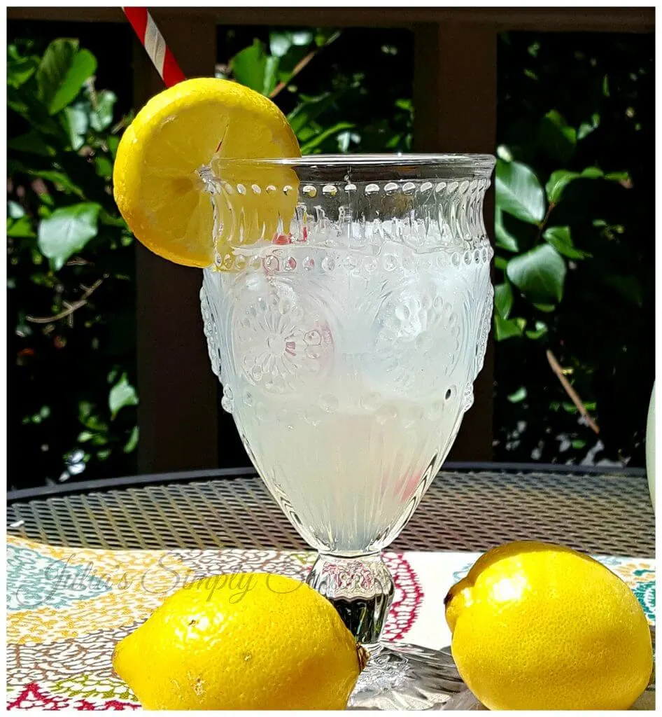 glass of lemonade garnished with a slice of fresh lemon