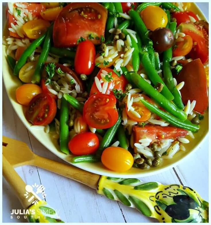 Easy Green Bean and Tomato Salad on a vintage yellow platter with beautiful salad utensils from Italy