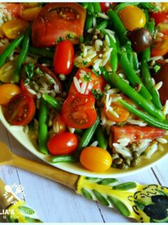 Easy Green Bean and Tomato Salad on a vintage yellow platter with beautiful salad utensils from Italy