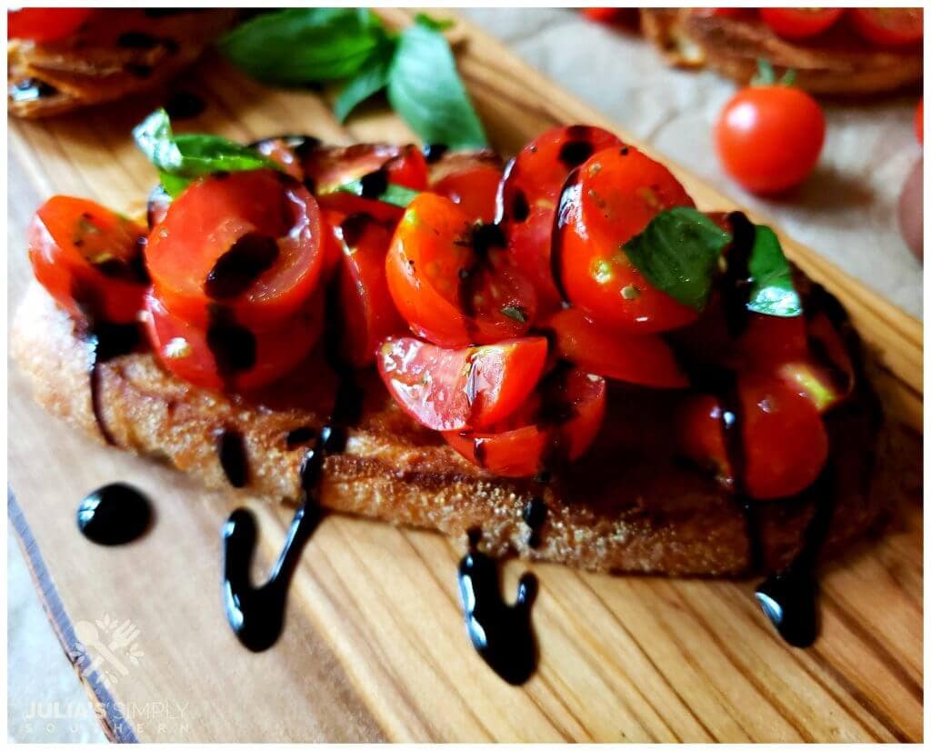 Bruschetta antipasto appetizer on a wooden serving board