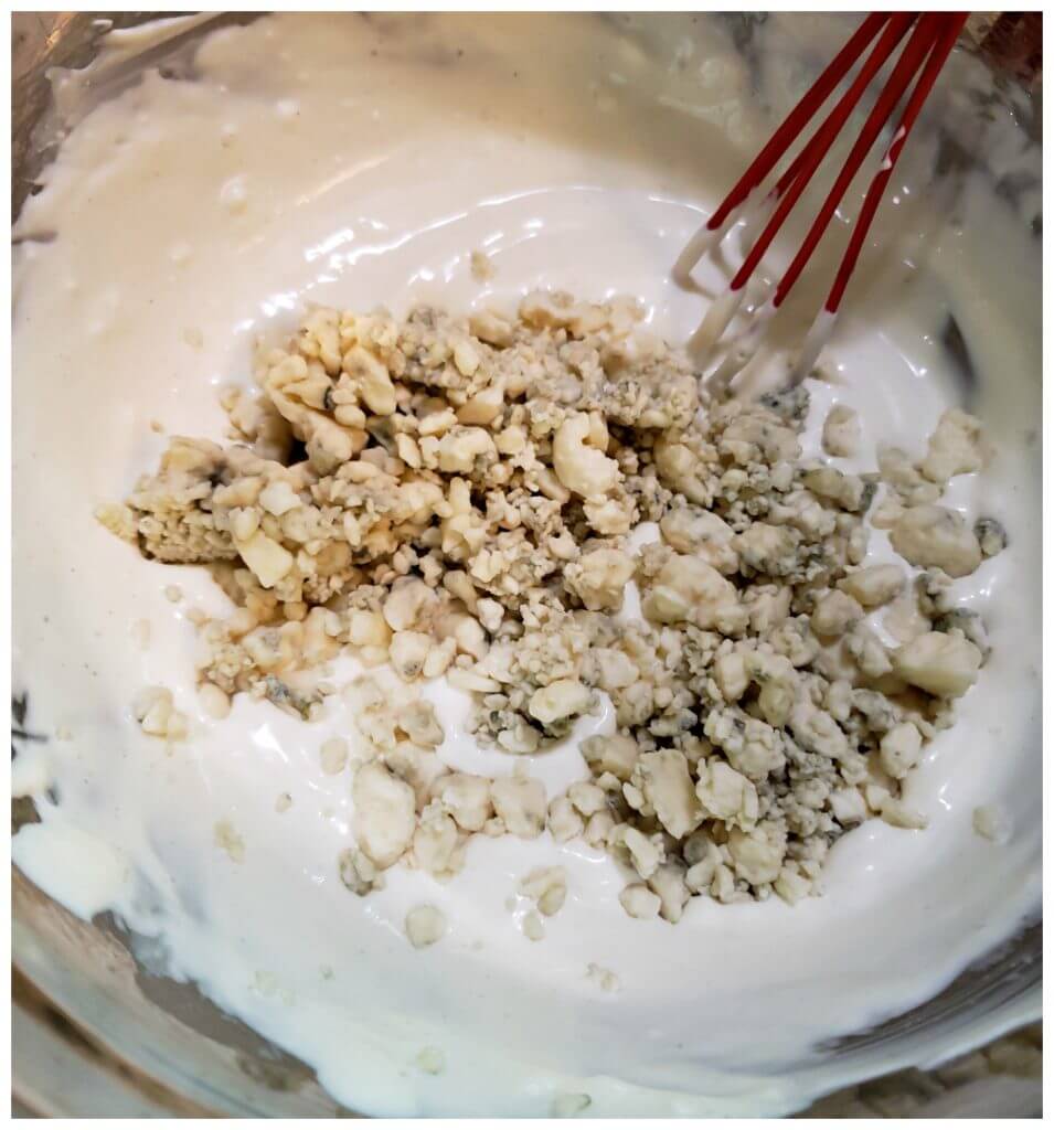 Mixing bowl filled with ingredients to make a blue cheese dressing
