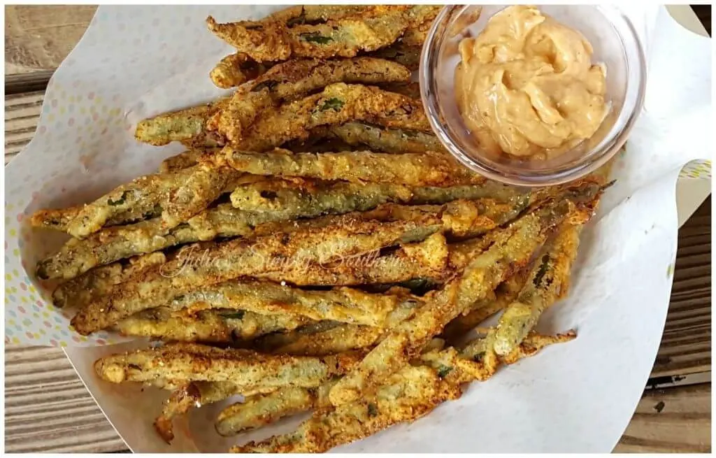 Fried green beans in a serving tray with remoulade dipping sauce