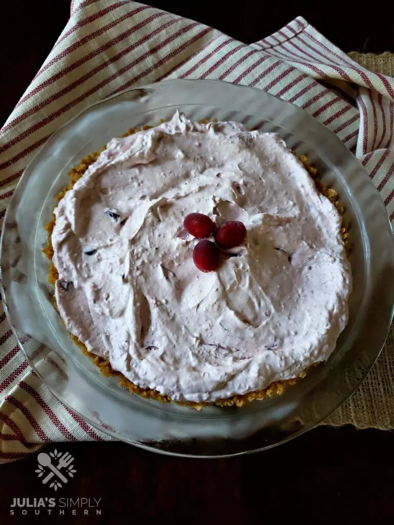Frosted cranberry pie in a glass pie dish