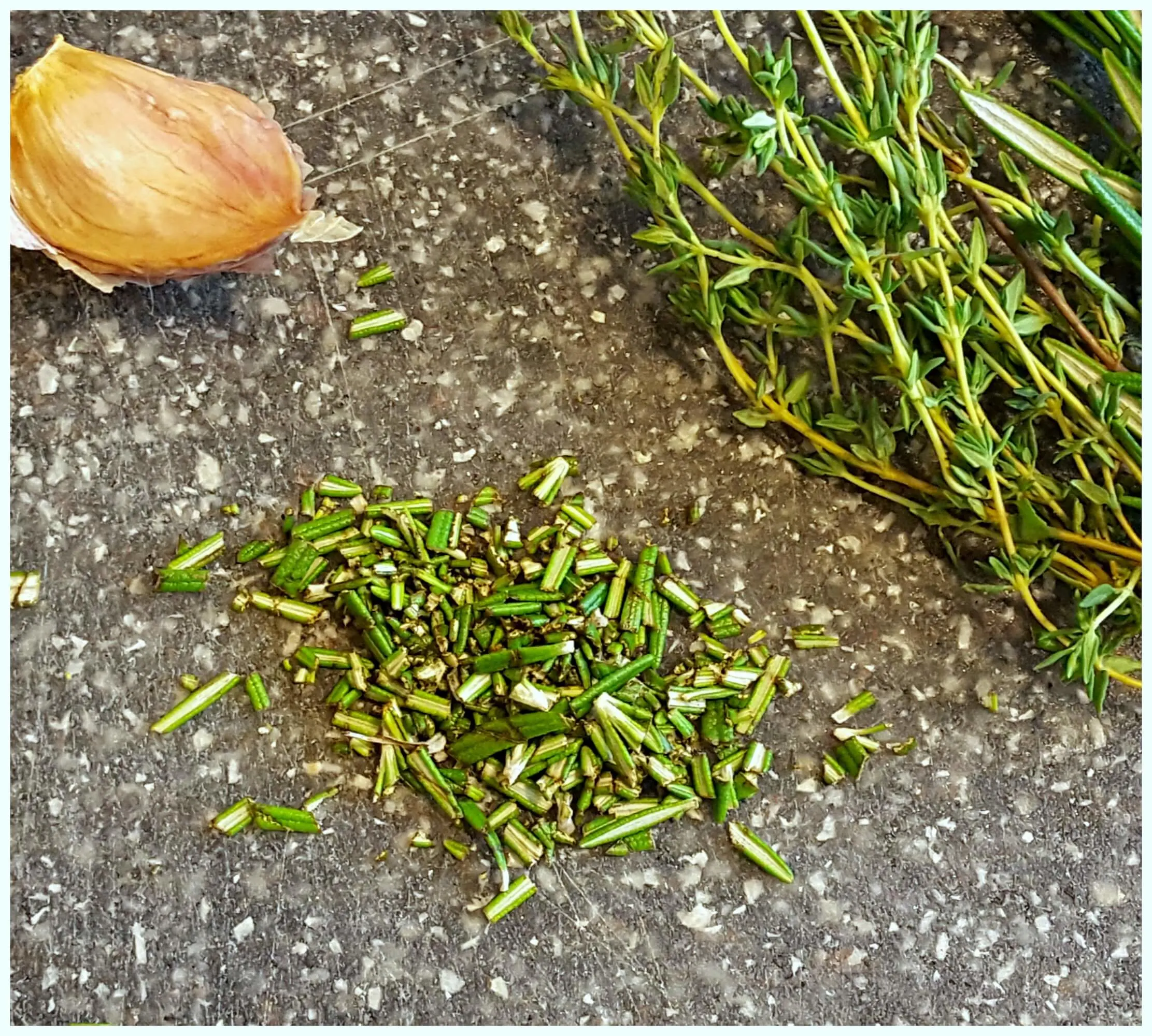 fresh herbs and garlic on a cutting board