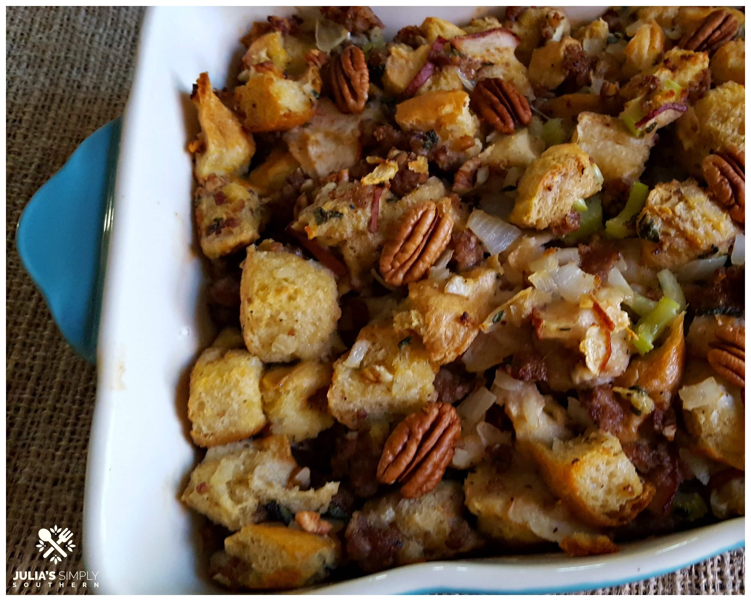 Sausage Pear Stuffing with Pecans in a blue Pioneer Woman casserole dish