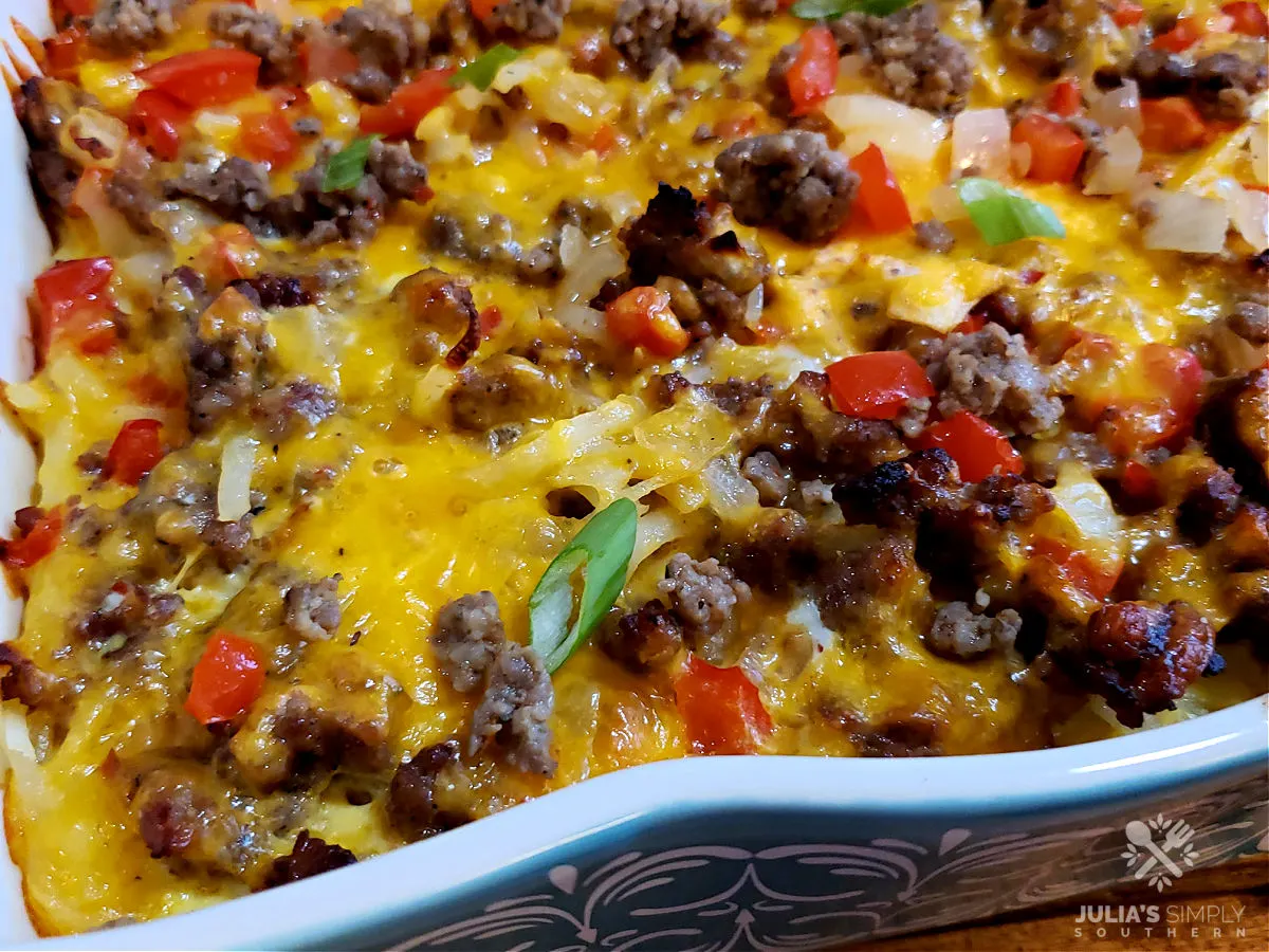 Hash Brown Breakfast Casserole with sausage, eggs, cheese, onions and bell peppers in a Pioneer Woman baking dish