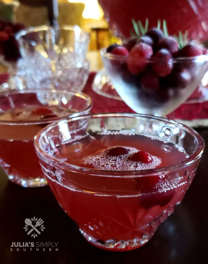 Christmas Cranberry punch in crystal glass with fresh frozen cranberries