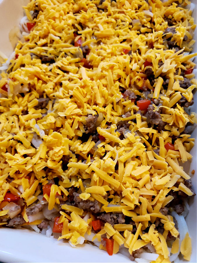 Layering Simple hash brown breakfast casserole for holiday mornings meal