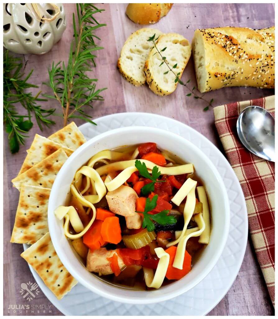 Best chicken noodle soup from the Crockpot with crackers and bread