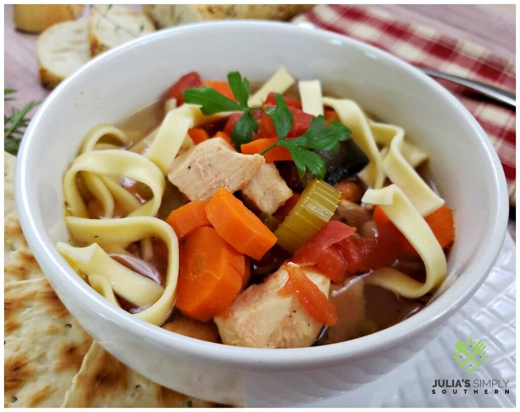 Fresh vegetable, chicken and egg noodle soup prepared in a slow cooker 