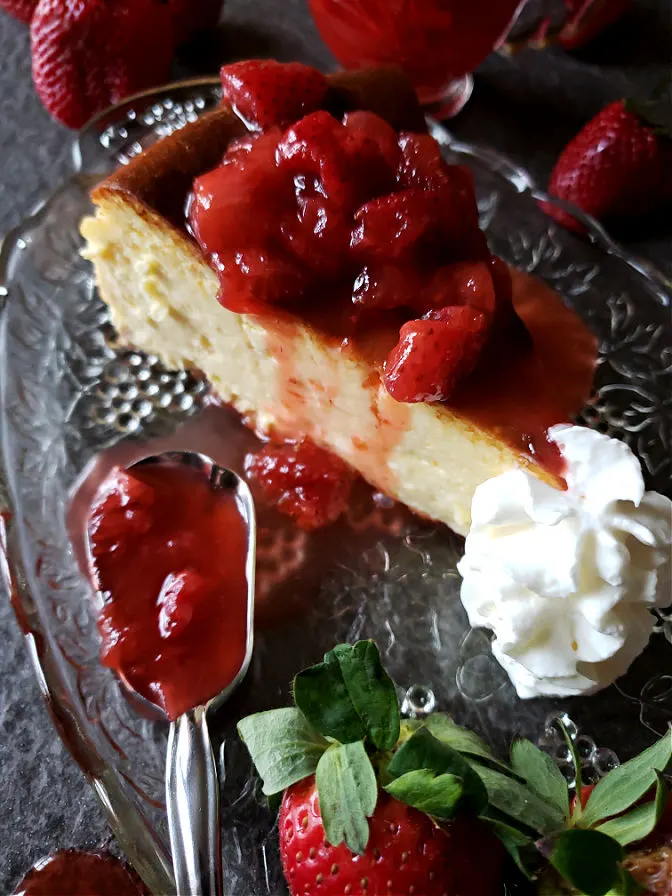 Dessert slice on a plate with berry sauce