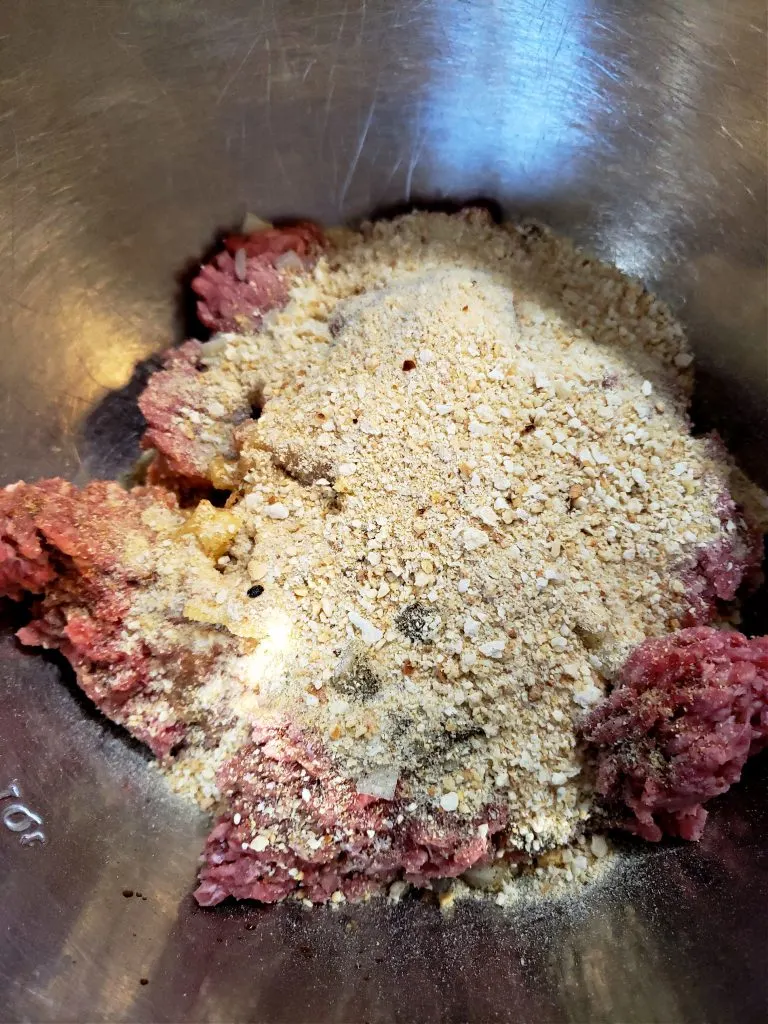 mixing up meat mixture in a mixing bowl