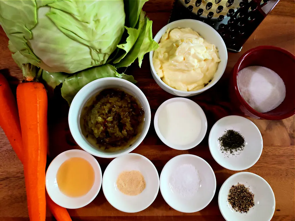 traditional homemade Southern coleslaw recipe ingredients on a wooden cutting board