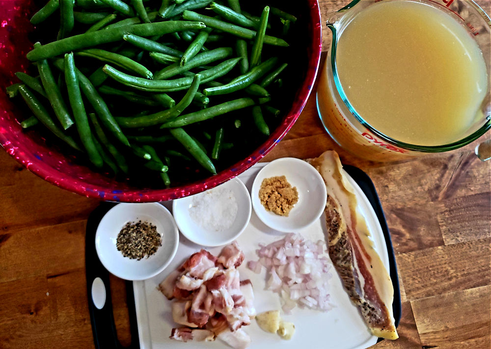 Ingredients for making Southern soul food green beans in a slow cooker - fresh string beans, chicken stock, seasonings, bacon and side meat