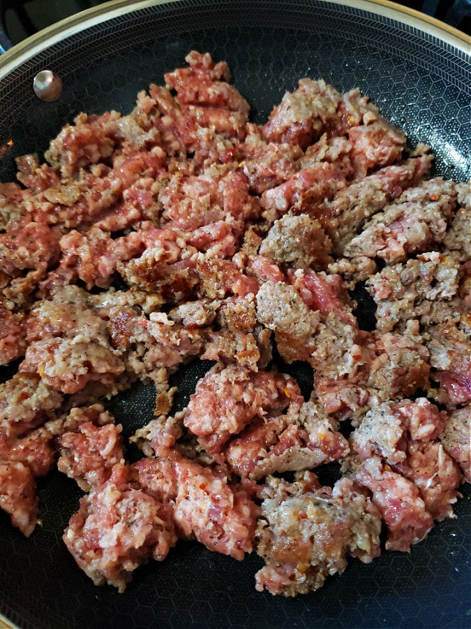 Browning and mincing pork sausage in a skillet