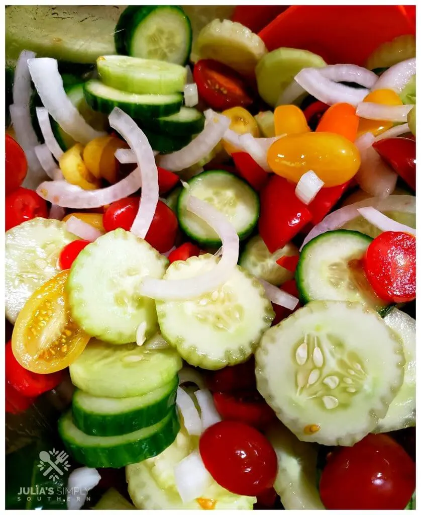 Ingredients for making a colorful cucumber salad in a mixing bowl