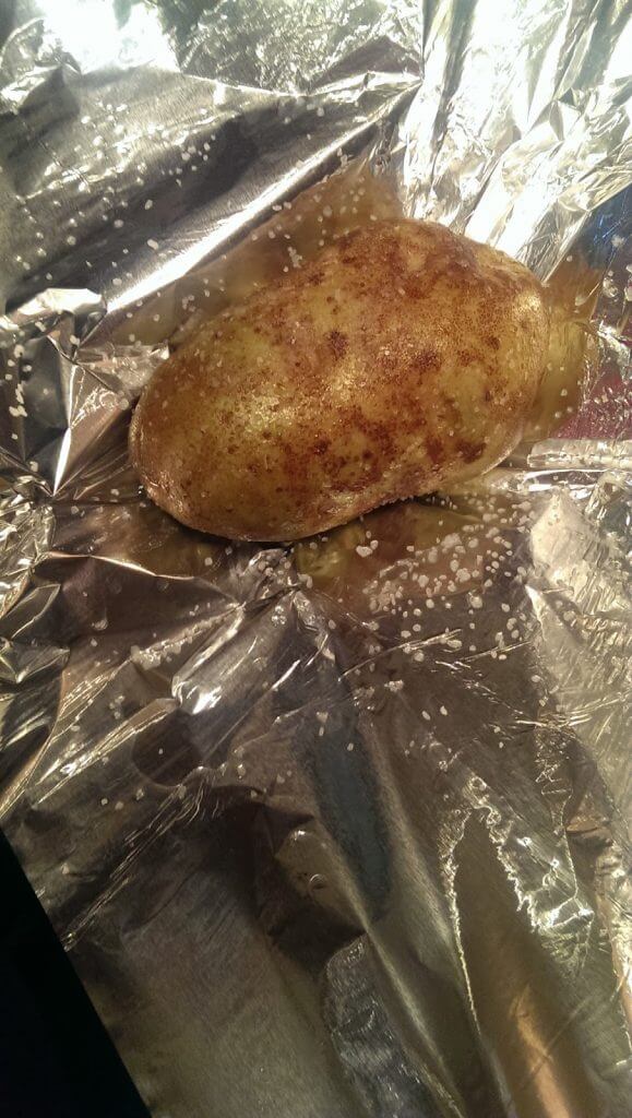 wrapping a potato in foil for baking