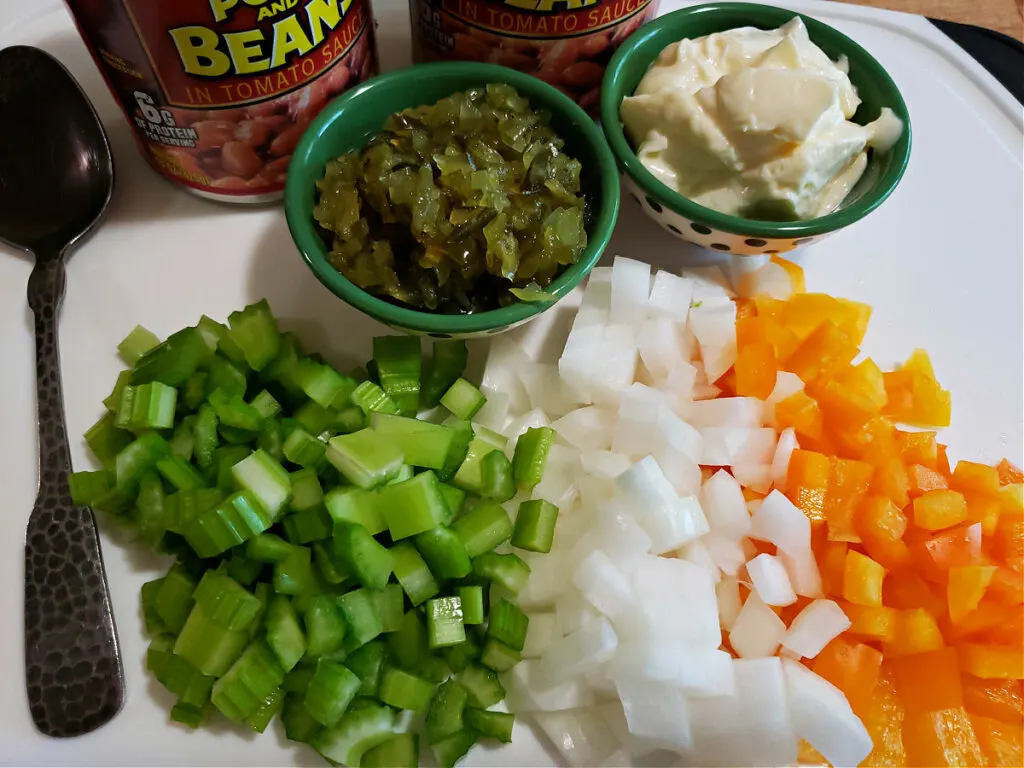 Ingredients for making a pork and beans salad with canned baked beans
