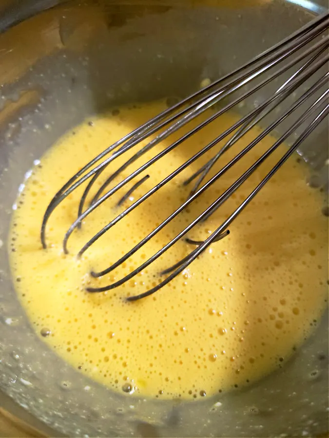 whisking duck eggs