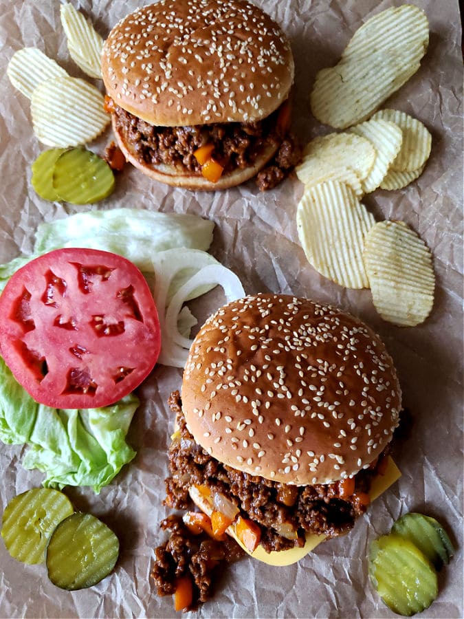 Sloppy Joe sandwiches with topping options served with potato chips. Homemade Sloppy Joes recipe.