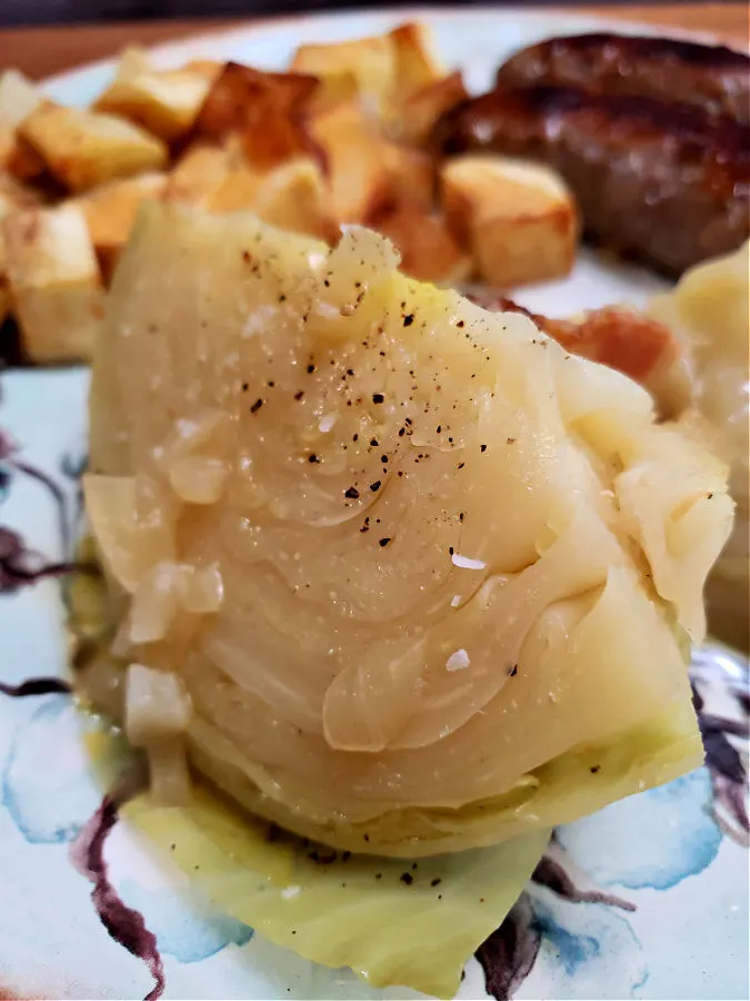 Green cabbage cooked southern-style served with fried russet potatoes and bratwurst