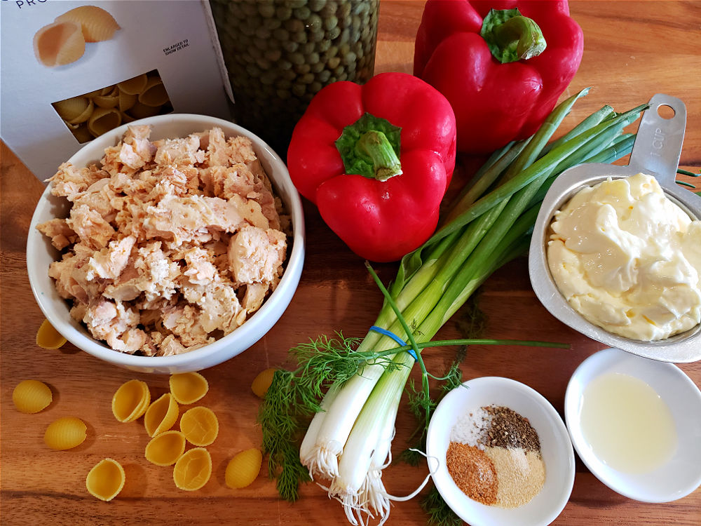 Serving board with ingredients for making a salmon pasta salad