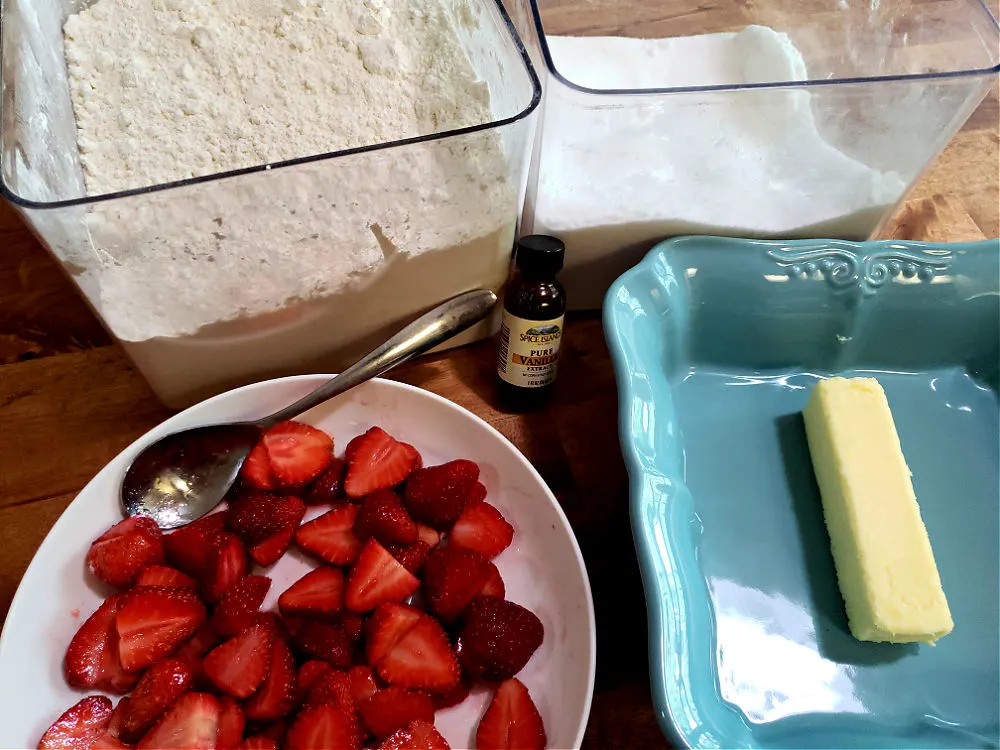 Perfect Ingredients list for an easy strawberry cobbler baked fruit dessert with fresh strawberries that have been washed and prepared - no lemon juice needed