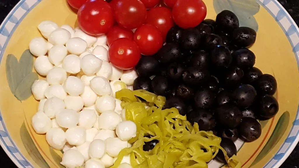Cherry tomatoes, black olives, pepperocini and small mozzarella balls for a pasta salad 