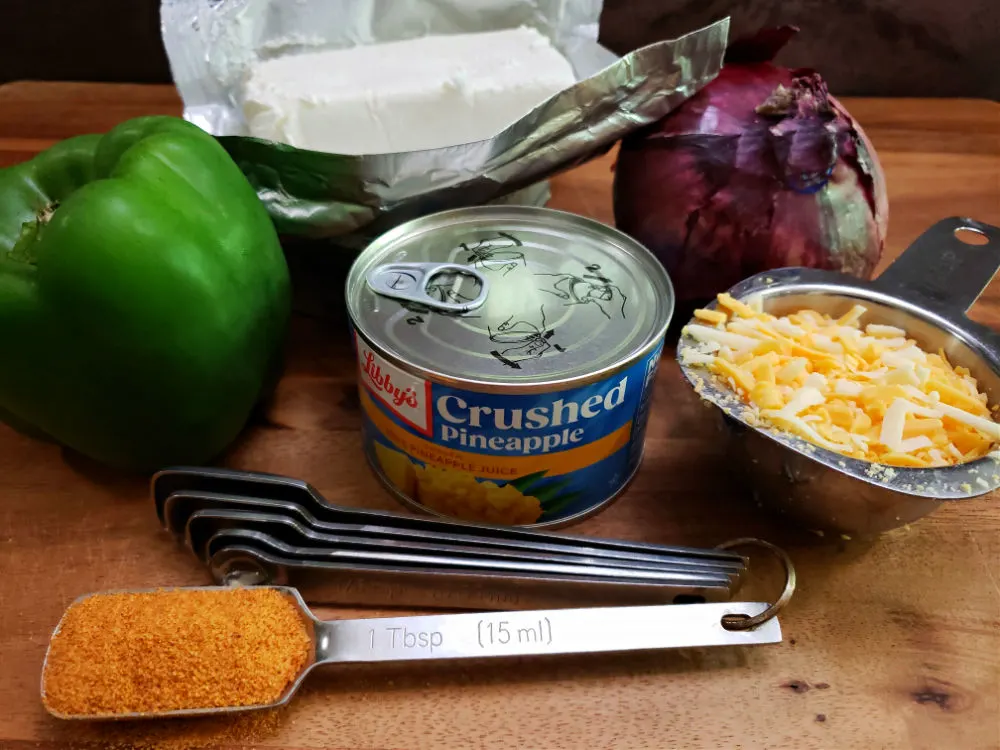 ingredients for preparing a pineapple cheese ball on a cutting board