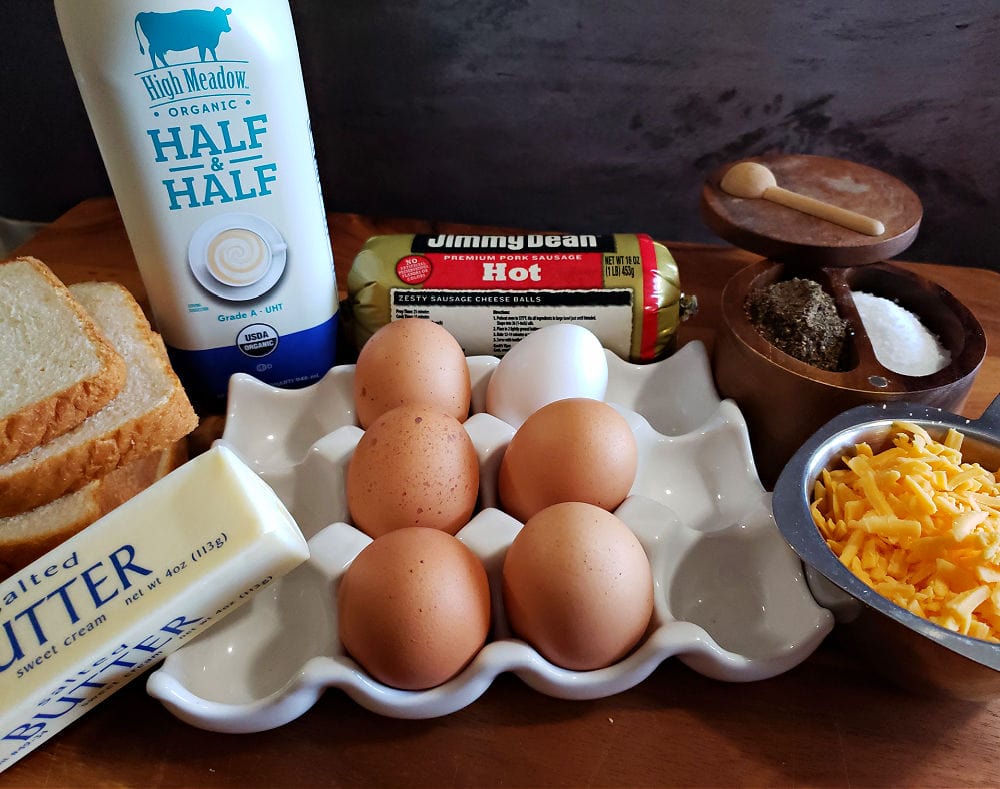 A wooden cutting board with the ingredients to prepare an overnight breakfast casserole recipe