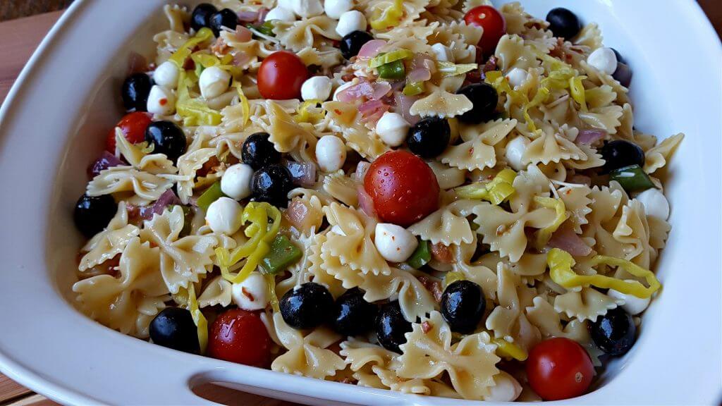 White platter with handles filled with an Italian Pasta Salad side dish recipe