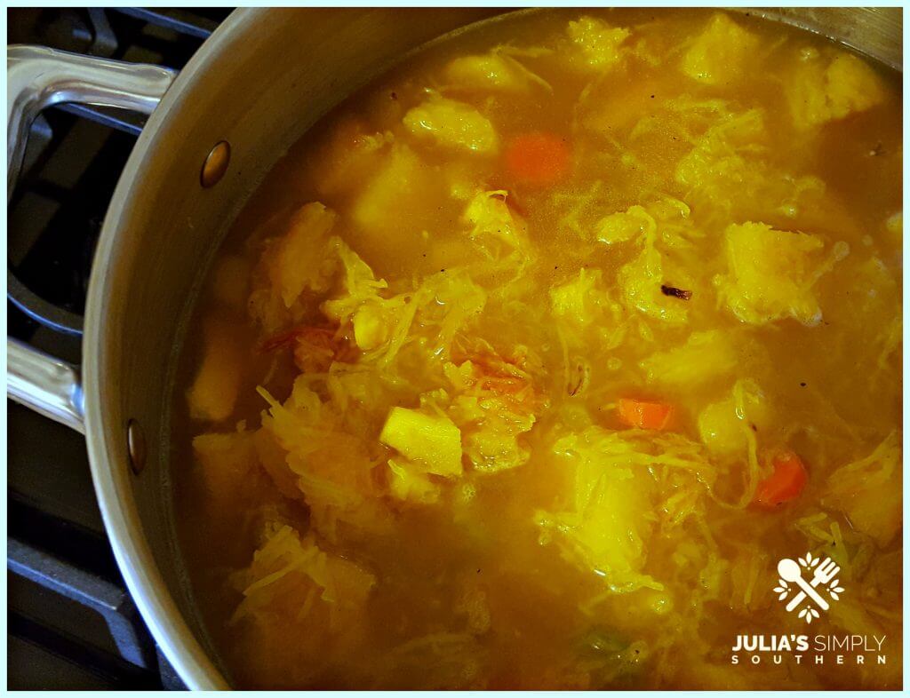 Making fresh pumpkin soup in a stainless soup pot on a gas stove top