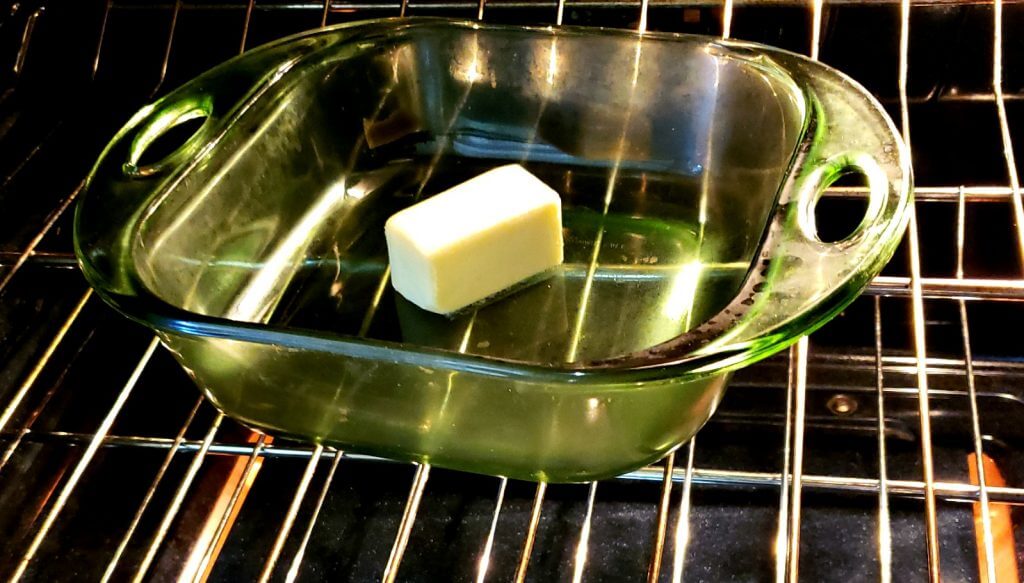 glass baking dish in oven melting butter