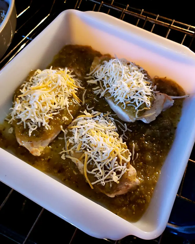 Baked chicken breasts in oven topped with cheese Mexican style cuisine