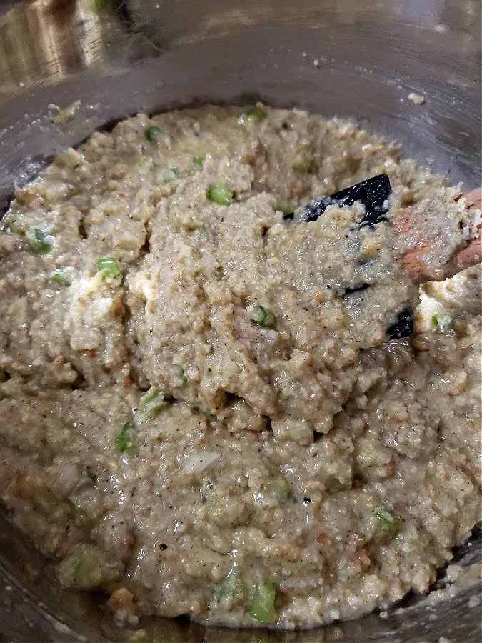 Cornbread dressing mixture in a large mixing bowl ready to pour into the Crock Pot crockery