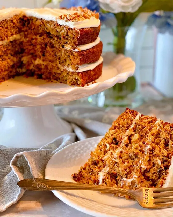 carrot cake on a plate with a fork