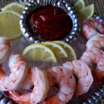 Classic Shrimp Cocktail Sauce Recipe - served on a bed of crushed ice and lemon slices - easy appetizer