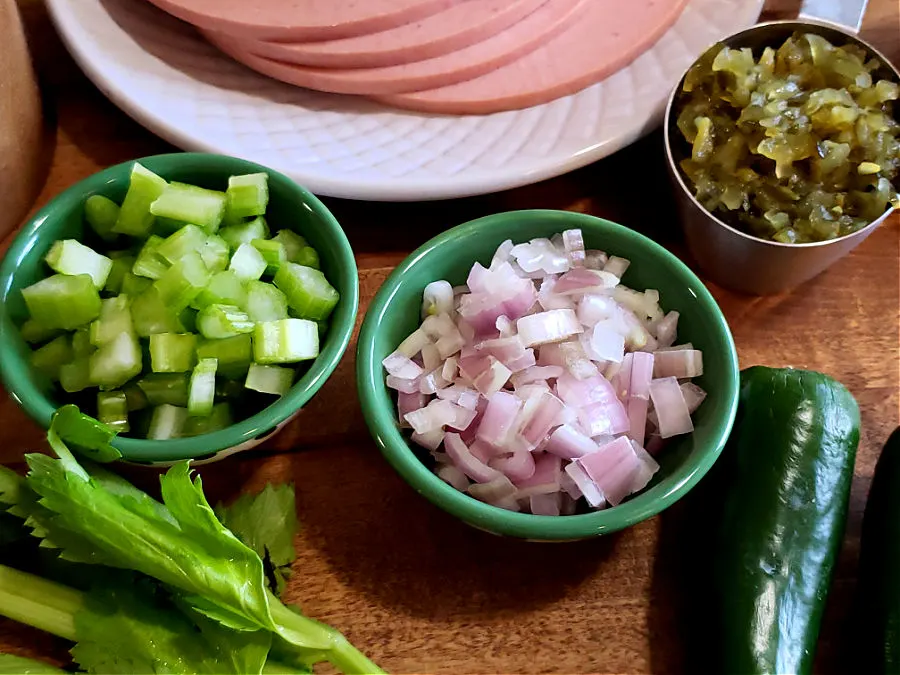 sliced deli bolonga with diced vegetables and sweet relish