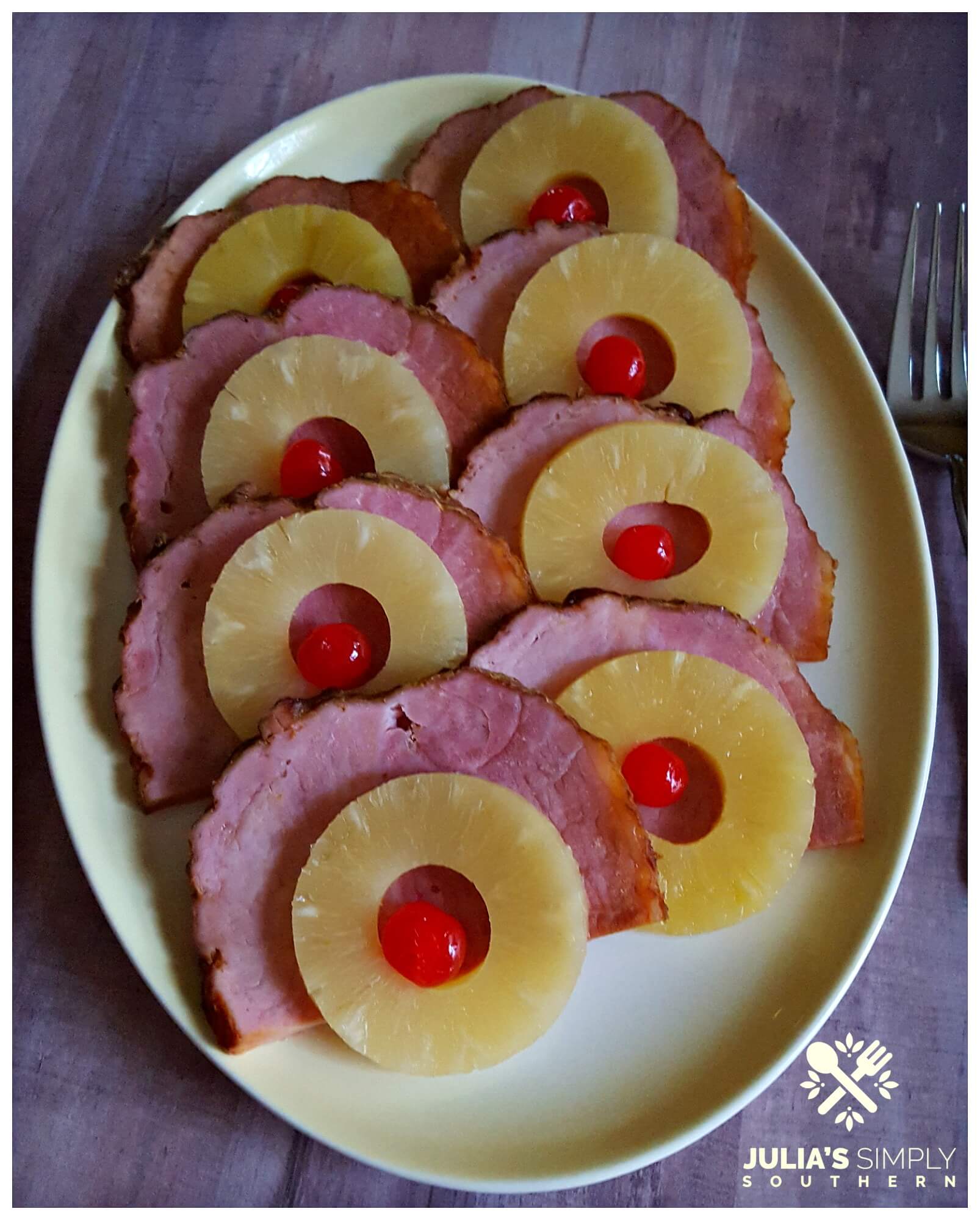 Oval platter with Thanksgiving ham slices topped with pineapple and cherries