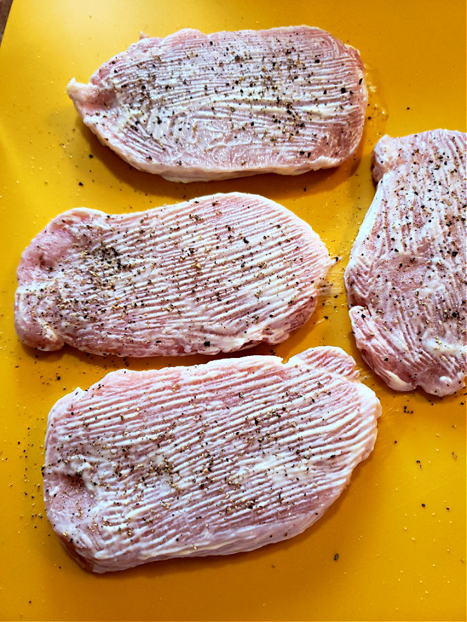 pork chops brushed with mayonnaise before coating in bread crumbs for baking