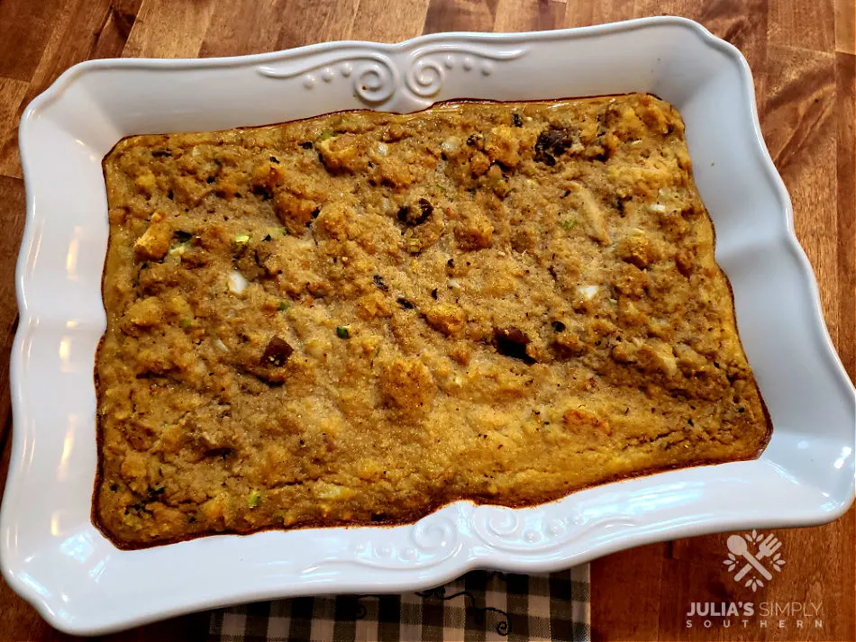 Baked cornbread dressing with seafood in a white baking dish